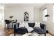 Cozy living room with a comfortable sofa, decorative pillows, and elegant wall art at 1206 S Reed St, Lakewood, CO 80232
