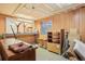 Basement shop area featuring wood paneling, a window, and assorted storage and tables at 18538 E Whitaker Cir # A, Aurora, CO 80015