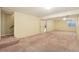 View of the basement featuring neutral carpet and lighting with stairs visible in the background at 18538 E Whitaker Cir # A, Aurora, CO 80015