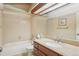Standard bathroom featuring a shower-tub combo, vanity with solid surface countertop, and a framed mirror at 18538 E Whitaker Cir # A, Aurora, CO 80015