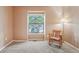 Bedroom featuring carpeted floors, a window, and a rocking chair at 18538 E Whitaker Cir # A, Aurora, CO 80015