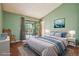 Staged bedroom with vaulted ceiling, large sliding door, and ensuite bathroom at 18538 E Whitaker Cir # A, Aurora, CO 80015