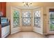 Charming dining area with bay window, built-in cabinetry, and tile floor at 18538 E Whitaker Cir # A, Aurora, CO 80015