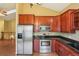 Bright kitchen with granite countertops, stainless appliances, and ample cabinet space at 18538 E Whitaker Cir # A, Aurora, CO 80015