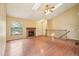 Open living room featuring a stone fireplace, hardwood floors, and ample natural light at 18538 E Whitaker Cir # A, Aurora, CO 80015