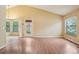 Bright living room with vaulted ceiling, hardwood floors, and large windows at 18538 E Whitaker Cir # A, Aurora, CO 80015