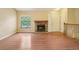 Inviting living room featuring a stone fireplace, large window, and a warm, welcoming atmosphere at 18538 E Whitaker Cir # A, Aurora, CO 80015