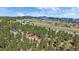 Breathtaking aerial shot of the property, surrounded by verdant trees and rolling hills with mountain views at 24701 Us Hwy 40, Golden, CO 80401