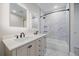 Modern bathroom featuring a double vanity, updated fixtures, and a tub with a tiled shower at 24701 Us Hwy 40, Golden, CO 80401