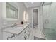 Bright primary bathroom featuring double vanity with marble countertops and glass shower at 24701 Us Hwy 40, Golden, CO 80401