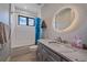 Bathroom featuring a vanity with marble countertop, updated fixtures, and a shower over tub with tiled walls at 24701 Us Hwy 40, Golden, CO 80401