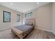 Neutral bedroom featuring a wooden bed frame, hardwood floors, and natural light from multiple windows at 24701 Us Hwy 40, Golden, CO 80401