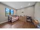 Well-lit bedroom showcasing hardwood floors, a large window view, and space for customized decor at 24701 Us Hwy 40, Golden, CO 80401