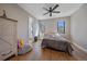 Bedroom with hardwood floors, ceiling fan, comfortable bed, and natural light at 24701 Us Hwy 40, Golden, CO 80401