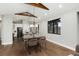 Dining room with view of kitchen, hardwood floors, beams, and modern chandelier at 24701 Us Hwy 40, Golden, CO 80401