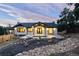 Beautifully landscaped home with a covered patio and well-maintained backyard at 24701 Us Hwy 40, Golden, CO 80401