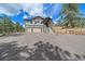 Two-story home with a three-car garage, stone accents, and an inviting covered entryway at 24701 Us Hwy 40, Golden, CO 80401