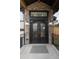 Close-up of the exquisite front door with ornate metalwork and stone surround at 24701 Us Hwy 40, Golden, CO 80401