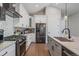 Modern kitchen with white cabinets, marble countertops, and stainless steel appliances at 24701 Us Hwy 40, Golden, CO 80401