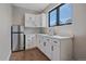 This cozy kitchenette features bright white cabinets, stone countertops, and modern stainless steel appliances at 24701 Us Hwy 40, Golden, CO 80401