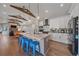 Spacious kitchen with marble countertops, stainless steel appliances, and blue stools at 24701 Us Hwy 40, Golden, CO 80401