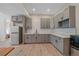 Charming kitchen with gray cabinets, stainless steel appliances, and white subway tile backsplash at 24701 Us Hwy 40, Golden, CO 80401