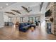 Bright living room featuring a stone fireplace, exposed beams and hardwood floors at 24701 Us Hwy 40, Golden, CO 80401