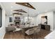 Living room with stone fireplace, hardwood floors, beams, and modern chandelier at 24701 Us Hwy 40, Golden, CO 80401