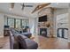 Cozy living room with a stone fireplace, large windows, and wood-look floors at 24701 Us Hwy 40, Golden, CO 80401