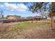 Expansive backyard with lush lawn, pergola, and mature trees offers ample space for outdoor activities at 6755 Garrison St, Arvada, CO 80004