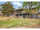 View of the large backyard and multi-level deck from the yard, showcasing the outdoor space at 6755 Garrison St, Arvada, CO 80004