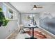 Bright home office features neutral walls, mountain accent wall, large windows, and a ceiling fan at 6755 Garrison St, Arvada, CO 80004