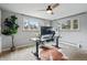 Bright bedroom features neutral walls, large windows, ceiling fan, and a home office setup at 6755 Garrison St, Arvada, CO 80004