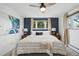 Comfortable bedroom with natural light, ceiling fan, and stylish wall art at 6755 Garrison St, Arvada, CO 80004