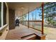 Covered porch featuring wood plank flooring, railing, and exposed beams creates a cozy outdoor living space at 6755 Garrison St, Arvada, CO 80004