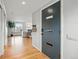 Warm entryway leading to a bright living space with hardwood floors and modern accents at 6755 Garrison St, Arvada, CO 80004