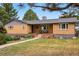 Traditional brick home featuring a covered front porch, perfect for relaxing outdoors at 6755 Garrison St, Arvada, CO 80004