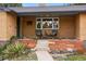 Inviting front porch with chairs, complemented by brick planters and lush landscaping at 6755 Garrison St, Arvada, CO 80004