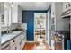 View from the kitchen shows white cabinetry and a dining area with round table and chairs at 6755 Garrison St, Arvada, CO 80004