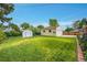Well-maintained backyard featuring a detached garage, shed, and lush green lawn at 2121 W 73Rd Pl, Denver, CO 80221