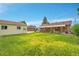 Spacious backyard with green lawn, detached garage, and covered patio area for outdoor enjoyment at 2121 W 73Rd Pl, Denver, CO 80221