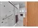 Bathroom featuring white tiles, glass enclosed shower, and a wood vanity with a sink at 2121 W 73Rd Pl, Denver, CO 80221