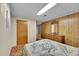 Cozy bedroom with wood paneling, built-in dresser, and comfortable bedding, perfect for relaxation at 2121 W 73Rd Pl, Denver, CO 80221
