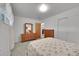 Spacious bedroom with hardwood furniture, dresser, and neutral-colored bedding at 2121 W 73Rd Pl, Denver, CO 80221