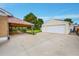 Long concrete driveway leading to the detached garage and covered patio area at 2121 W 73Rd Pl, Denver, CO 80221