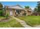 Charming single-story home with a well-manicured lawn and cozy front porch setting at 2121 W 73Rd Pl, Denver, CO 80221