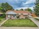 Attractive home with a brick facade, manicured lawn, and covered front porch at 2121 W 73Rd Pl, Denver, CO 80221