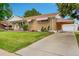 Suburban home with mature landscaping, a driveway, and a detached garage at 2121 W 73Rd Pl, Denver, CO 80221