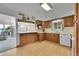 Charming kitchen featuring wooden cabinets, a double basin sink, and a breakfast bar area at 2121 W 73Rd Pl, Denver, CO 80221