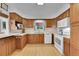 Functional kitchen features wood cabinets, white appliances, and ample counter space for meal prep at 2121 W 73Rd Pl, Denver, CO 80221